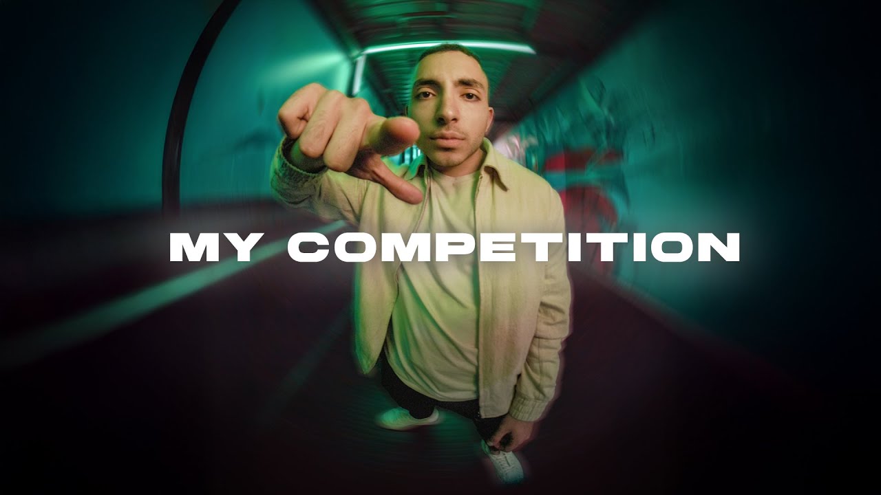 BEAST pointing at the camera in a teal-lit tunnel, the MY COMPETITION thumbnail